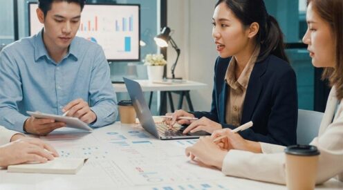 Business professionals analyzing data charts and collaborating on data strategy at a conference table