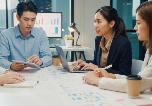 Business professionals analyzing data charts and collaborating on data strategy at a conference table