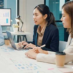 Business professionals analyzing data charts and collaborating on data strategy at a conference table